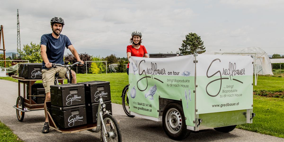 The image shows how  Gredlbauer delivers their ecological products on a cargo bike.