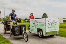 The image shows how  Gredlbauer delivers their ecological products on a cargo bike.